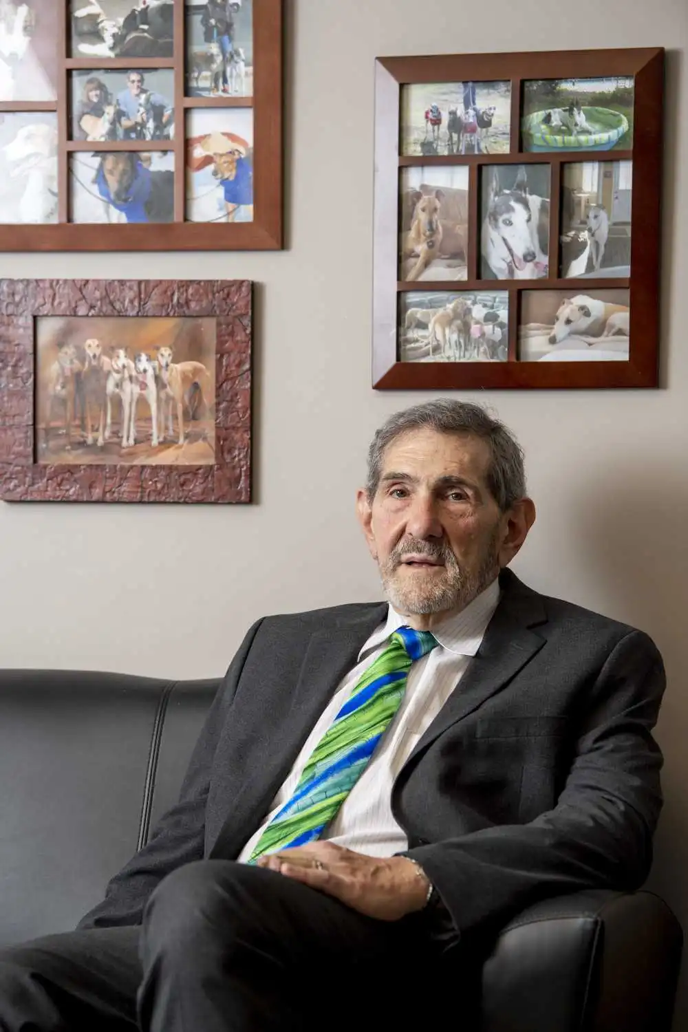 Richard Bruce Rosenthal in his office, surrounded by photographs of dogs he has defended.